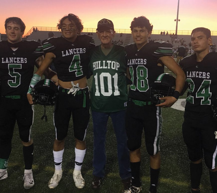 Earlier this year World War II veteran and former Hilltop High School teacher Thomas Rice (center) was honored during halftime of a football game. The 98 year old on Thursday had the school library named in his honor, just ahead of the Veterans Day holiday.